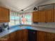 Bright kitchen featuring a corner sink, modern appliances, and a charming window view at 3104 E Broadway Rd # 212, Mesa, AZ 85204