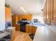 Well-appointed kitchen with light wood cabinets, and black appliances at 3104 E Broadway Rd # 212, Mesa, AZ 85204