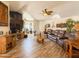Expansive living room with stylish wood floors, a ceiling fan, and ample seating at 3104 E Broadway Rd # 212, Mesa, AZ 85204