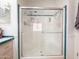 Modern shower with glass doors, built-in seating, and dual shower heads at 3104 E Broadway Rd # 212, Mesa, AZ 85204