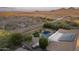 Aerial view of the backyard oasis and desert surroundings with a pool and solar panels at 31703 N 15Th Dr, Phoenix, AZ 85085