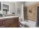 Bathroom showcasing a white sink, wood cabinets, tile backsplash, and a shower with a tiled tub at 31703 N 15Th Dr, Phoenix, AZ 85085
