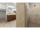 Primary bathroom featuring dual vanities, neutral tile flooring, and a walk-in shower at 31703 N 15Th Dr, Phoenix, AZ 85085