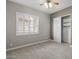 Bright bedroom with a large window, neutral walls, plush carpet, and a spacious closet at 31703 N 15Th Dr, Phoenix, AZ 85085