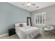Bedroom features light blue wall, a full bed, and natural lighting at 31703 N 15Th Dr, Phoenix, AZ 85085
