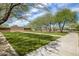 Well-manicured community park with grassy lawns, trees, and pathways at 31703 N 15Th Dr, Phoenix, AZ 85085