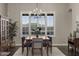Inviting dining room featuring a classic wood table, stylish seating, and large windows with scenic views at 31703 N 15Th Dr, Phoenix, AZ 85085