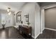 Welcoming entryway with hardwood floors, console table with mirror, and a white front door at 31703 N 15Th Dr, Phoenix, AZ 85085