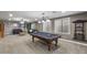 Spacious game room featuring a billiard table, comfortable seating, and three large windows at 31703 N 15Th Dr, Phoenix, AZ 85085