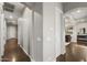 Hallway with hardwood floors leading to rooms and an arched entrance to the living room at 31703 N 15Th Dr, Phoenix, AZ 85085