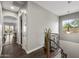 Hallway featuring hardwood flooring, and staircase with wood and iron banister at 31703 N 15Th Dr, Phoenix, AZ 85085