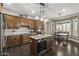 Stylish kitchen with wood cabinets, stainless steel appliances, and a functional center island, perfect for cooking at 31703 N 15Th Dr, Phoenix, AZ 85085