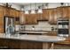Gourmet kitchen boasts wood cabinets, tiled backsplash, and stainless steel appliances for modern living at 31703 N 15Th Dr, Phoenix, AZ 85085