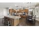 Expansive kitchen features custom wood cabinetry, granite countertops, and stainless steel appliances at 31703 N 15Th Dr, Phoenix, AZ 85085