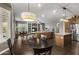 Open concept kitchen and living area features a large kitchen island, hardwood floors and a pendant light at 31703 N 15Th Dr, Phoenix, AZ 85085