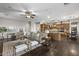 Bright, open-concept living room with a comfortable sectional, stylish decor, and seamless flow to the kitchen at 31703 N 15Th Dr, Phoenix, AZ 85085