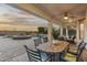 Inviting covered patio with dining and lounge areas overlooking the tranquil pool and fire pit at 31703 N 15Th Dr, Phoenix, AZ 85085