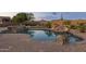 Inviting backyard pool and spa with rock waterfall feature and desert landscaping at 31703 N 15Th Dr, Phoenix, AZ 85085