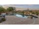 Gorgeous private backyard oasis, complete with pool, waterfall, and desert landscaping at 31703 N 15Th Dr, Phoenix, AZ 85085