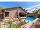 Outdoor patio area featuring a swimming pool, sun umbrella and outdoor seating surrounded by desert landscaping at 3207 E Behrend Dr, Phoenix, AZ 85050