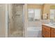 Bathroom featuring a walk-in shower and separate tub at 3207 E Behrend Dr, Phoenix, AZ 85050