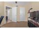 View of a bright bedroom showing interior doors, a TV, shelves with ornaments and light-colored walls at 3207 E Behrend Dr, Phoenix, AZ 85050