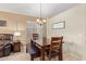Cozy dining room with a dark wood table, bench seating and chandelier lighting at 3207 E Behrend Dr, Phoenix, AZ 85050
