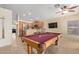 Game room with a pool table adjacent to a modern kitchen and bar seating at 3207 E Behrend Dr, Phoenix, AZ 85050