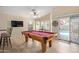 Spacious game room featuring a pool table, access to the pool, and tile flooring at 3207 E Behrend Dr, Phoenix, AZ 85050