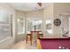 Cozy game room with three windows, dining area, and access to the pool at 3207 E Behrend Dr, Phoenix, AZ 85050