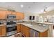 Well-equipped kitchen features stainless steel appliances and granite countertops at 3207 E Behrend Dr, Phoenix, AZ 85050