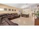 Open-concept living room with leather seating, a dining table, and a mounted TV at 3207 E Behrend Dr, Phoenix, AZ 85050