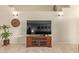 Neutral living room with a large television, ceramic tile flooring, and decor at 3207 E Behrend Dr, Phoenix, AZ 85050