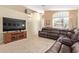 Comfortable living room with plush leather seating and natural light at 3207 E Behrend Dr, Phoenix, AZ 85050