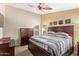 Comfortable primary bedroom with ceiling fan, carpeted floors, and lots of natural light at 3207 E Behrend Dr, Phoenix, AZ 85050