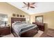 Relaxing primary bedroom suite with stylish dark wood furniture and a ceiling fan at 3207 E Behrend Dr, Phoenix, AZ 85050