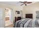 Primary bedroom offers a peek into en-suite bath, carpet floors and a large window at 3207 E Behrend Dr, Phoenix, AZ 85050