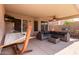 Comfortable covered patio with a hammock, outdoor seating, a ceiling fan and a grill at 3207 E Behrend Dr, Phoenix, AZ 85050