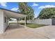 Spacious backyard featuring a covered patio, large grassy area, and a tall privacy fence at 3307 N Apollo Dr, Chandler, AZ 85224