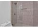Modern shower with glass door, bronze fixtures, and stylish tiled walls with a built-in niche at 3307 N Apollo Dr, Chandler, AZ 85224