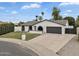 Charming single-story home featuring a lush front lawn, arched windows, and a spacious driveway at 3307 N Apollo Dr, Chandler, AZ 85224
