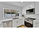 Bright kitchen featuring modern appliances and white cabinetry with gold hardware at 3307 N Apollo Dr, Chandler, AZ 85224