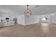 Open-concept living space featuring laminate floors, modern lighting, and a breakfast bar at 3307 N Apollo Dr, Chandler, AZ 85224