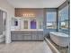 Luxury bathroom featuring double sinks, soaking tub, and a separate shower at 3421 S 256Th Ave, Buckeye, AZ 85326