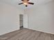 Neutral bedroom with wood-look flooring and white trim, leading to a hallway, for versatile design options at 3421 S 256Th Ave, Buckeye, AZ 85326