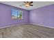 Bedroom featuring laminate flooring and a window with bright natural light at 3421 S 256Th Ave, Buckeye, AZ 85326