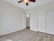 This bedroom features wood-look floors, a ceiling fan, and closet with sliding doors at 3421 S 256Th Ave, Buckeye, AZ 85326