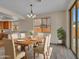 Dining room features table with seating for six near windows and sliding door to the backyard at 3421 S 256Th Ave, Buckeye, AZ 85326