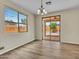 Well-lit dining room with laminate floors, large windows and a sliding door to the backyard at 3421 S 256Th Ave, Buckeye, AZ 85326