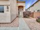 Inviting entrance with a covered porch, desert landscaping, and a walkway to the front door at 3421 S 256Th Ave, Buckeye, AZ 85326
